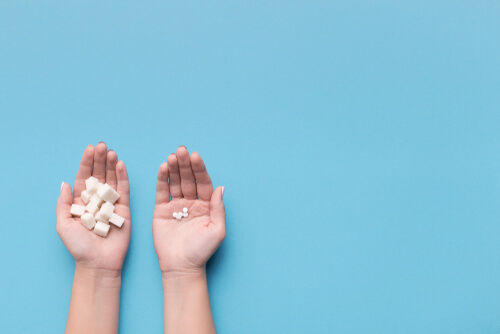 Female,Hands,With,Sugar,And,Pills,On,Blue,Background.,Choice