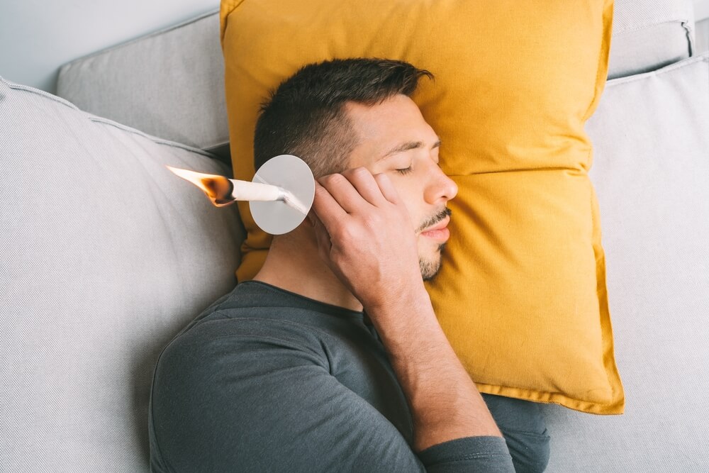 Young,Man,Having,Ear,Candle,Treatment,At,Home