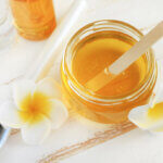 Glass,Jar,Of,Golden,Honey,Closep,With,Frangipani,Flowers.,Preparing