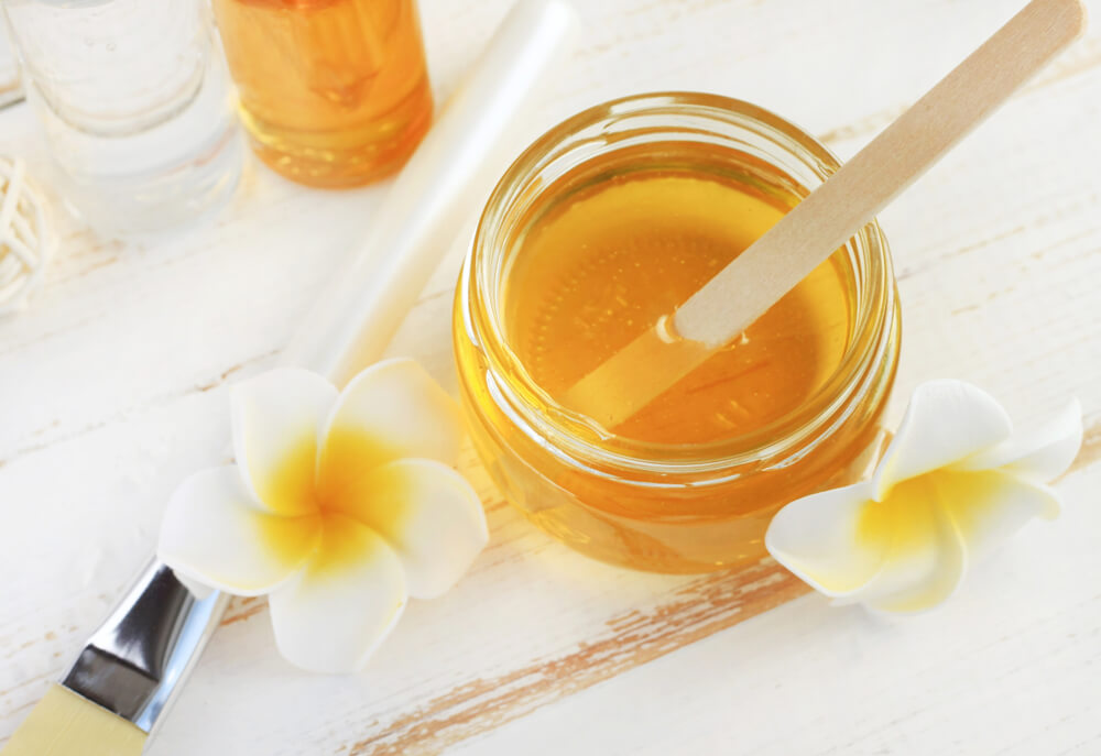 Glass,Jar,Of,Golden,Honey,Closep,With,Frangipani,Flowers.,Preparing