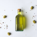 Top,View,Of,Glass,Bottle,With,Olive,Oil,And,Olives