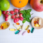 Multivitamin,Supplements,From,Fruit,On,White,Wood,Background,With,Wooden